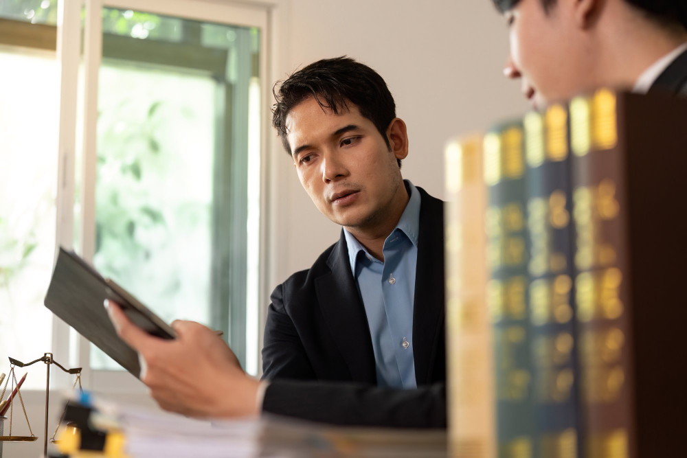 Focused lawyers closeup of attorney analyzing case documents in office